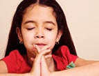 daily Devotion picture of little girl with brown hair praying with eyes closed