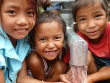 Three girls from Laos enjoy the fresh, clean water you provided. 