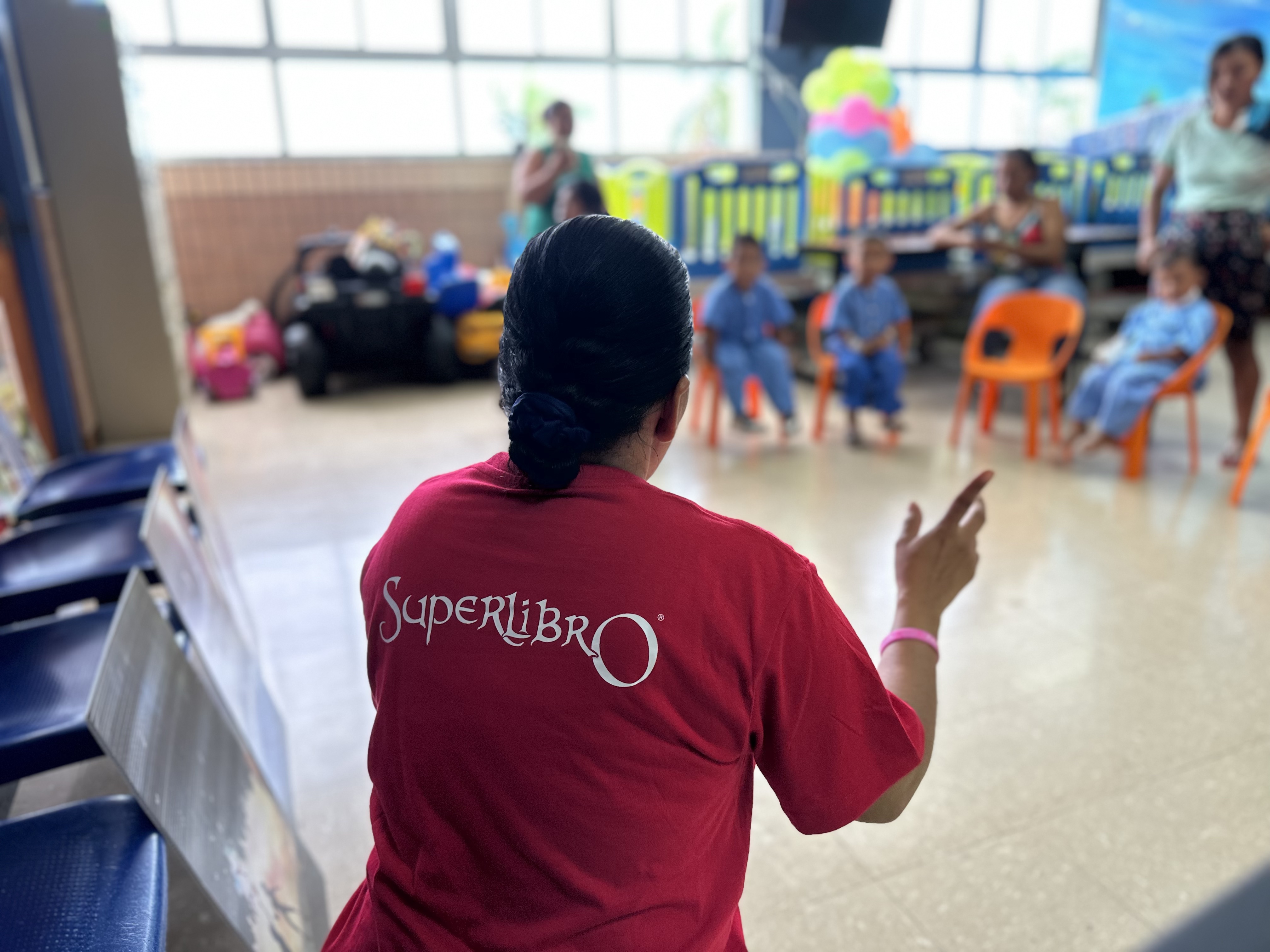 A member of the Superlibro team in Costa Rica speaks to children and their families at Tony Facio Pediatric Hospital.