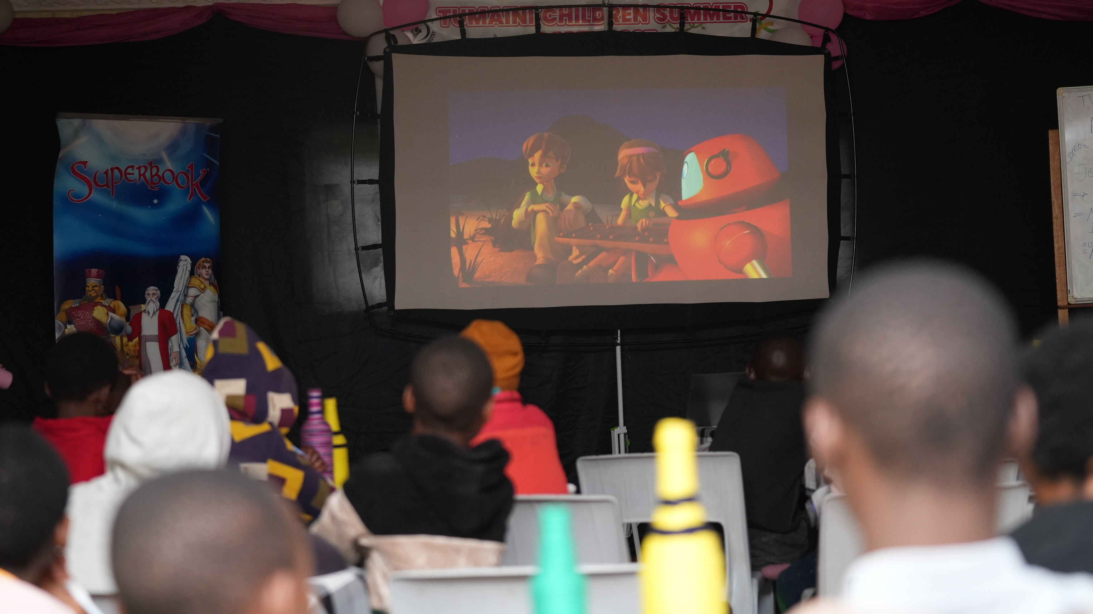 Children in Kenya watch a Superbook episode.