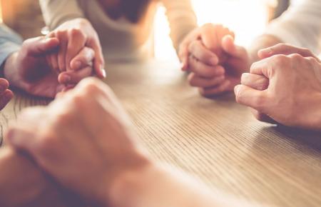 people joined together in prayer