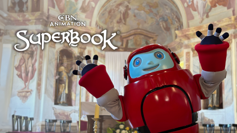 Gizmo stands excitedly in the sanctuary of the Church of St. Jerome in Strigova in Croatia. The CBN Animation and Superbook logos are stacked on the left.