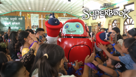 Children in Nepal surround Gizmo and reach for him as he smiles. The CBN Animation and Superbook logos are stacked in the upper right corner.