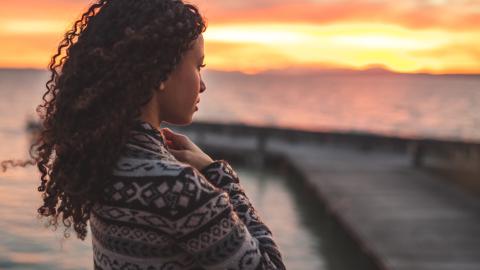 Reflective-woman-looking-at-ocean