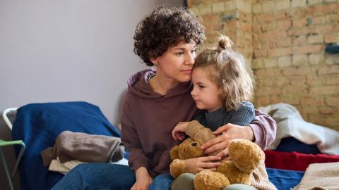 a homeless mother hugs her daughter