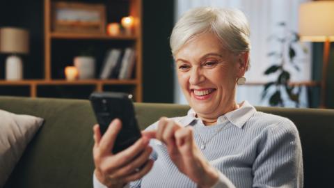 Woman reading and laughing on her phone