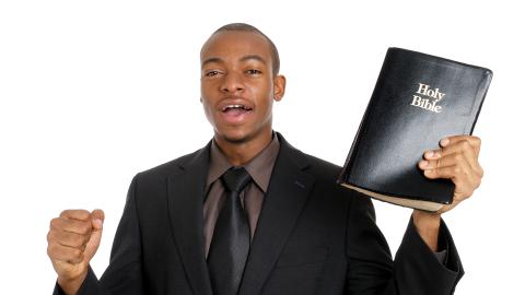 man preaching with a Bible in his hand