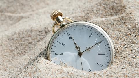 Pocket watch in the sand