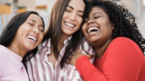 Three friends laughing together