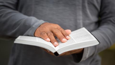 Man with hand on Bible
