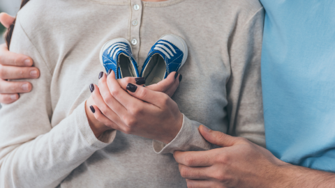 mother-holding-infant-shoes-1200.png