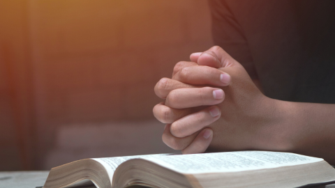 praying-hands-atop-bible-1200.png