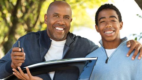 dad and son with car key