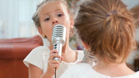 Young Girl Singing in front of a Mirror