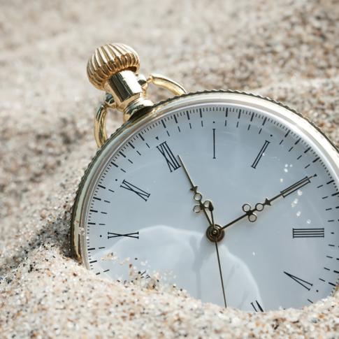 Pocket watch in the sand