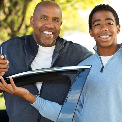 dad and son with car key