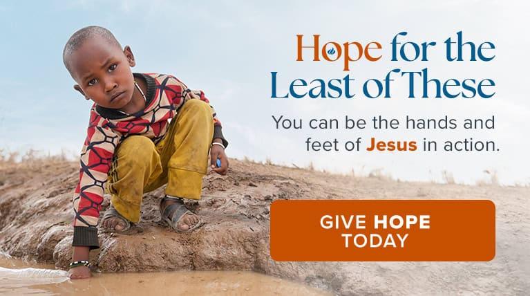 Boy wth hand in water